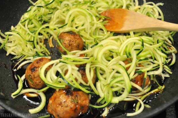 Thai turkey meatballs and zucchini noodles are added to glaze in skillet to cook for a few minutes.