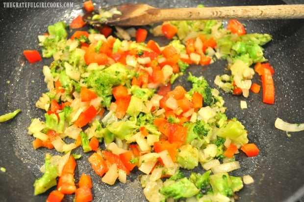 Chopped broccoli, red bell peppers, garlic and onion are cooked, before adding to the quiche.