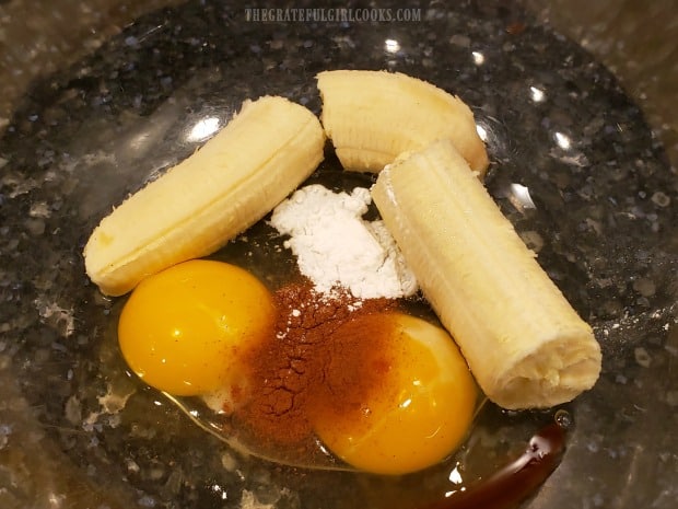Banana, eggs, cinnamon, baking powder and vanilla in bowl to make batter for pancakes.
