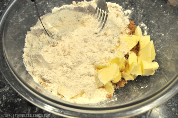 Butter, brown sugar and flour are mixed together to make crumb topping for the cake.