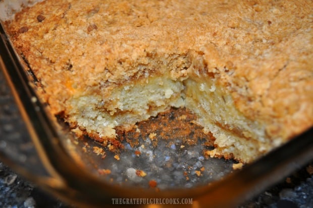 A piece has been removed from the banana crumb cake to reveal the inside.