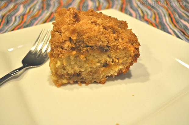 A slice of the banana crumb cake on a white plate, ready to eat!