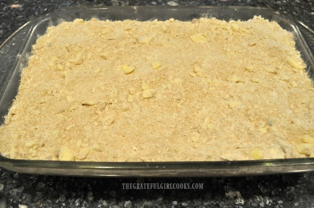 Banana crumb cake batter is topped with the crumb streusel topping before baking.
