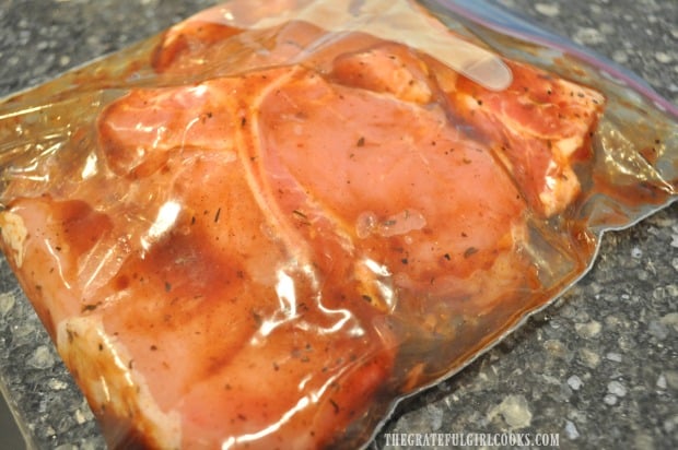 The bone-in pork chops marinate in the refrigerator for at least 30 minutes before cooking.