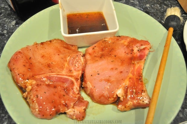 Marinated Caribbean jerk pork chops (and extra sauce) are ready to put on the grill.