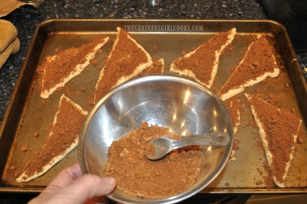 Dough is separated into 8 portions and covered with brown sugar/cinnamon filling.