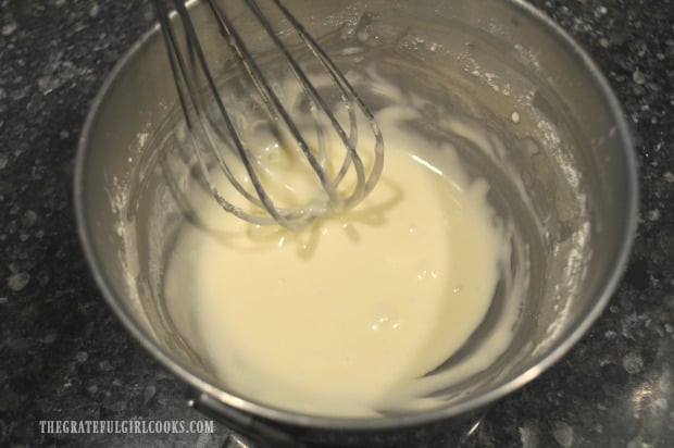 A simple glaze is mixed to drizzle onto the baked cinnamon roll crescents once done.