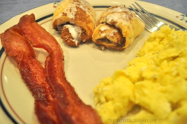 The cooked bacon is done perfectly, and served with cinnamon crescent rolls and scrambled eggs!