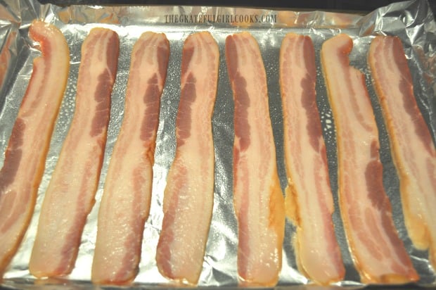Bacon is placed in a single layer on sprayed foil on baking sheet before cooking.