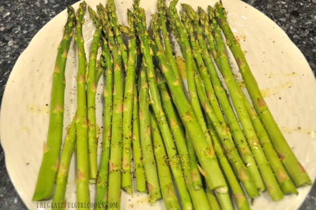 Fresh asparagus is drizzled with lemon juice and olive oil, and seasoned before grilling.