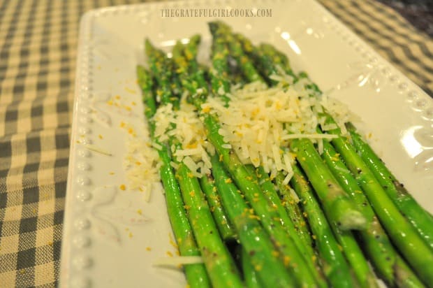 Grated Parmesan cheese and lemon zest help flavor and garnish the grilled asparagus.