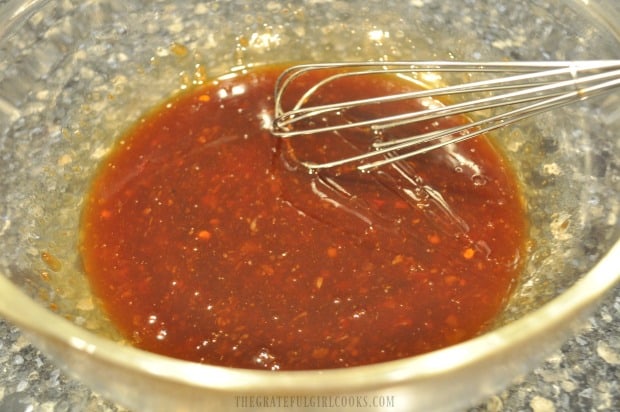 Whisking ingredients together for the sauce used to flavor sweet chili shrimp pasta.