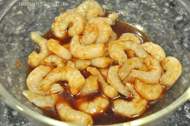 Large shrimp marinate in sauce to season them for the sweet chili shrimp pasta.