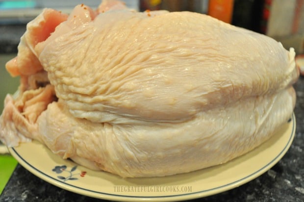 A whole turkey breast (bone-in) is rinsed, then patted dry before adding seasonings.