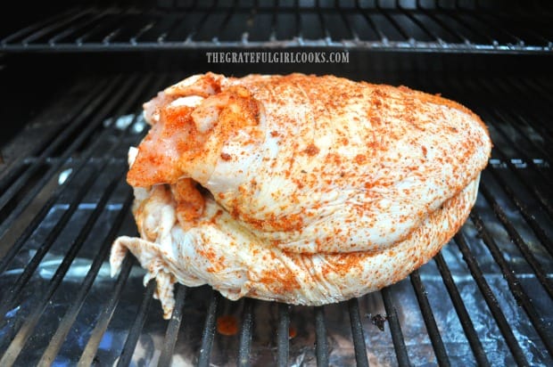 The Traeger roasted turkey breast is placed directly on the grill grate to cook.