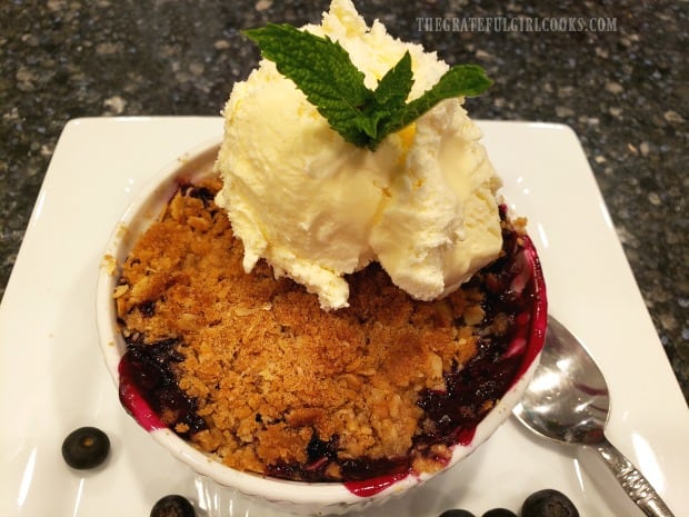 Blueberry Crumble is served with vanilla ice cream and a mint leaf on top!