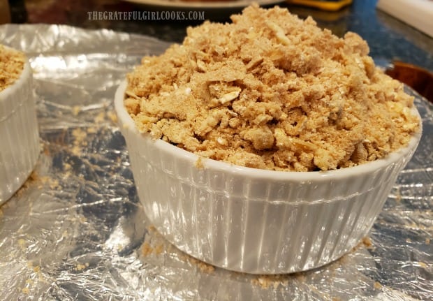The side view of a blueberry crumble before baking.