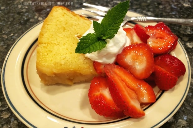 Glazed butter cake is served with strawberries and whipped cream, like a shortcake.