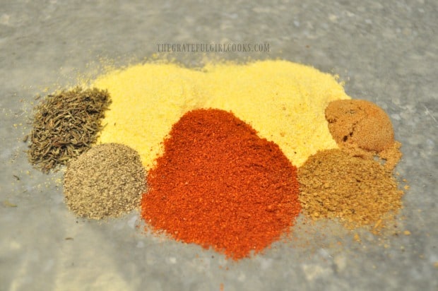 Spices are added to cornmeal to season the crust on the rockfish.