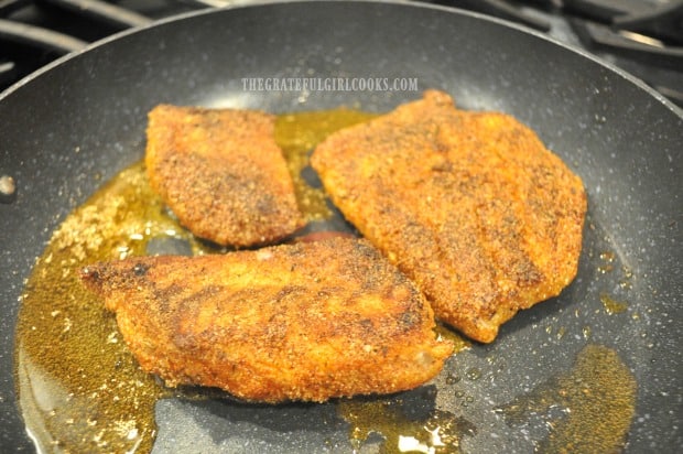 After fish cooks on one side, each fillet is flipped to cook the other side.