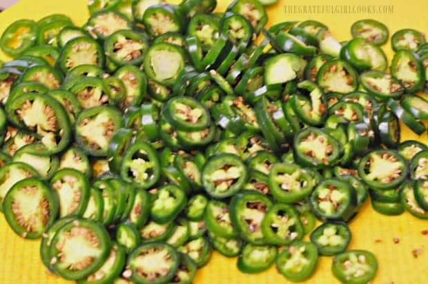 Jalapeños are thinly sliced before adding them to the pan.
