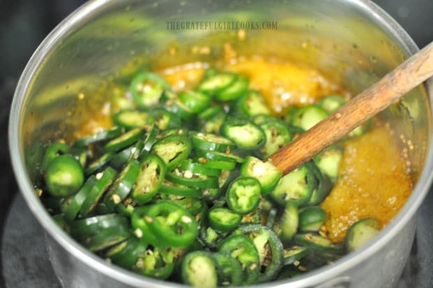 Thinly sliced jalapeños are added to and cooked in the thick syrup to make cowboy candy