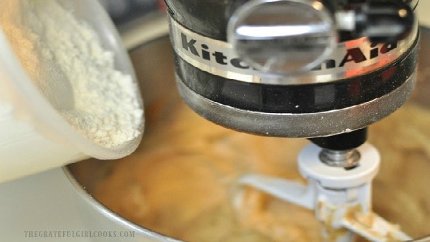 Dry ingredients are added to the cookie batter, a little at a time.