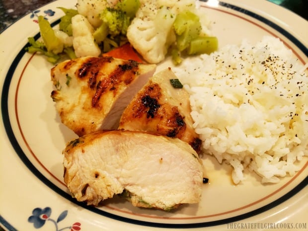 Flavorful garlic ginger sesame marinated chicken on plate with rice and steamed veggies.