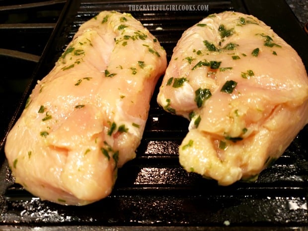 Marinated chicken is grilled on a hot, well-oiled grill pan.