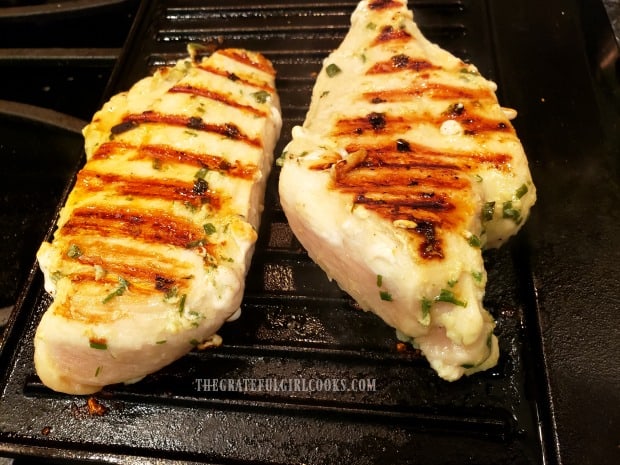 The garlic ginger sesame marinated chicken is turned over halfway through grilling time.