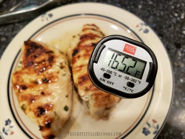 The meat thermometer says the chicken is fully cooked at 165 degrees F.