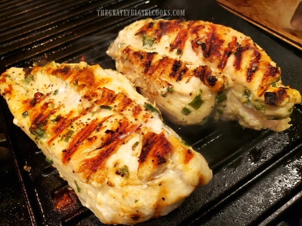 Two pieces of garlic ginger sesame marinated chicken cooking on indoor grill pan.