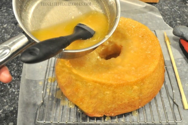 Holes are poked in top and sides of cake, then a butter glaze is added.