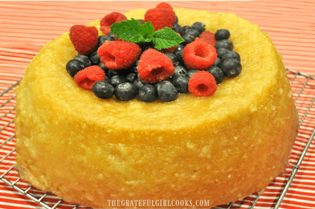 Fresh raspberries, blueberries & a mint sprig garnish the top of the glazed butter cake!
