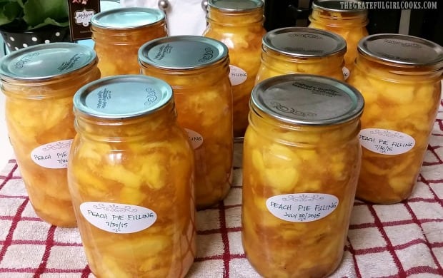 Labeled jars of peach pie filling have cooled and are ready to store in pantry.
