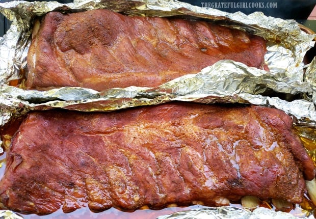 After two hours, the foil is removed from the racks of ribs.