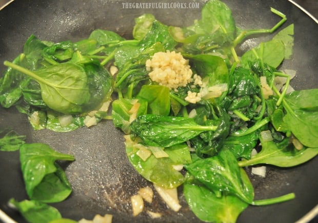 Spinach, onions and garlic cooking for the pasta dish.