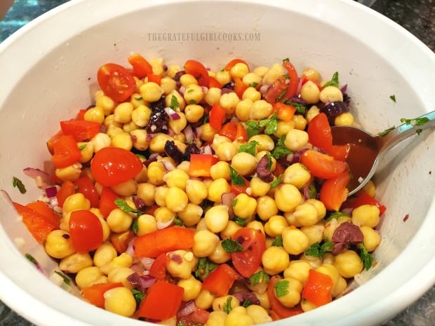 The salad ingredients are mixed to coat with the lemon/olive oil dressing.