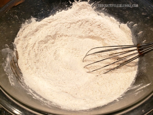 Flour, cinnamon, salt, baking powder and baking soda are whisked in bowl.