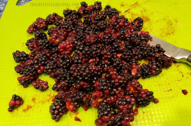 Blackberries are cut in half before adding to muffin batter.