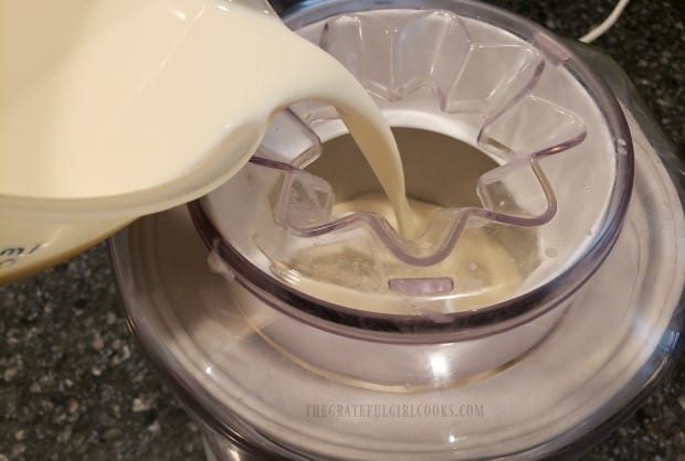 Pouring the ice cream base into the ice cream maker to begin freezing.