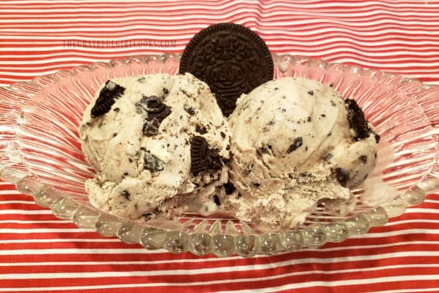 Two scoops of cookies n' cream ice cream in dish, with a cookie for garnish!