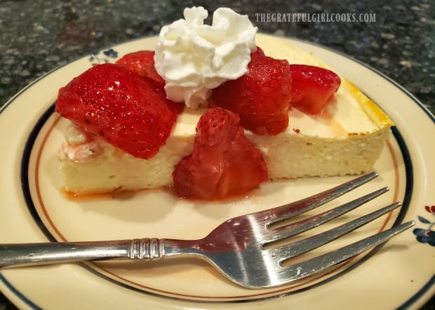 A slice of Freestyle 0 point cheesecake, with strawberries and whipped cream.