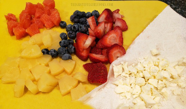 Pineapple, blueberries, strawberries, oranges and feta cheese ready for the salad.