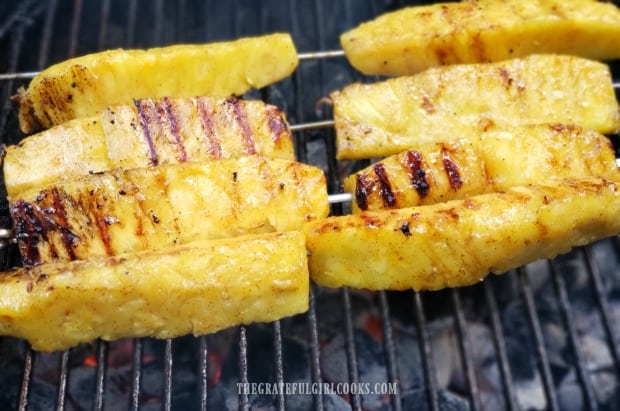 Grill marks beginning to show up after pineapple spears are rotated on grill.