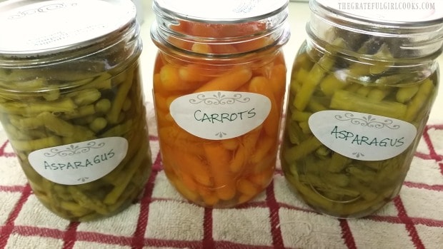 Jars of canned asparagus are labeled and ready to store in pantry.