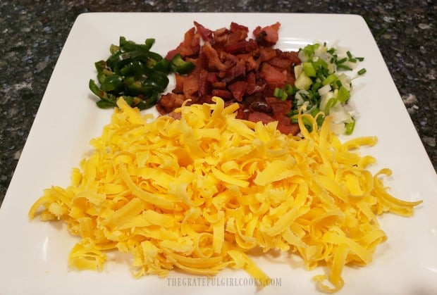 Grated cheese, jalapenos, green onions and crisp bacon are ready to add to grilled cauliflower.