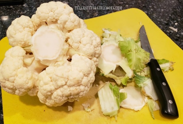 The leaves of the cauliflower and part of the stem are trimmed.