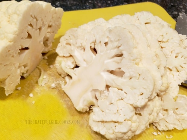 Cauliflower is sliced from top to bottom into 3/4" wide "steaks".