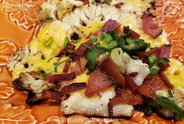 Close up view of one piece of grilled cauliflower with all the add-ons!